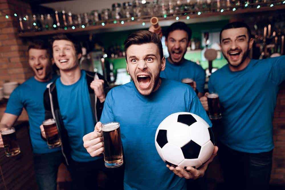 Watching the football with a couple of pints at the pub will save UK fans money